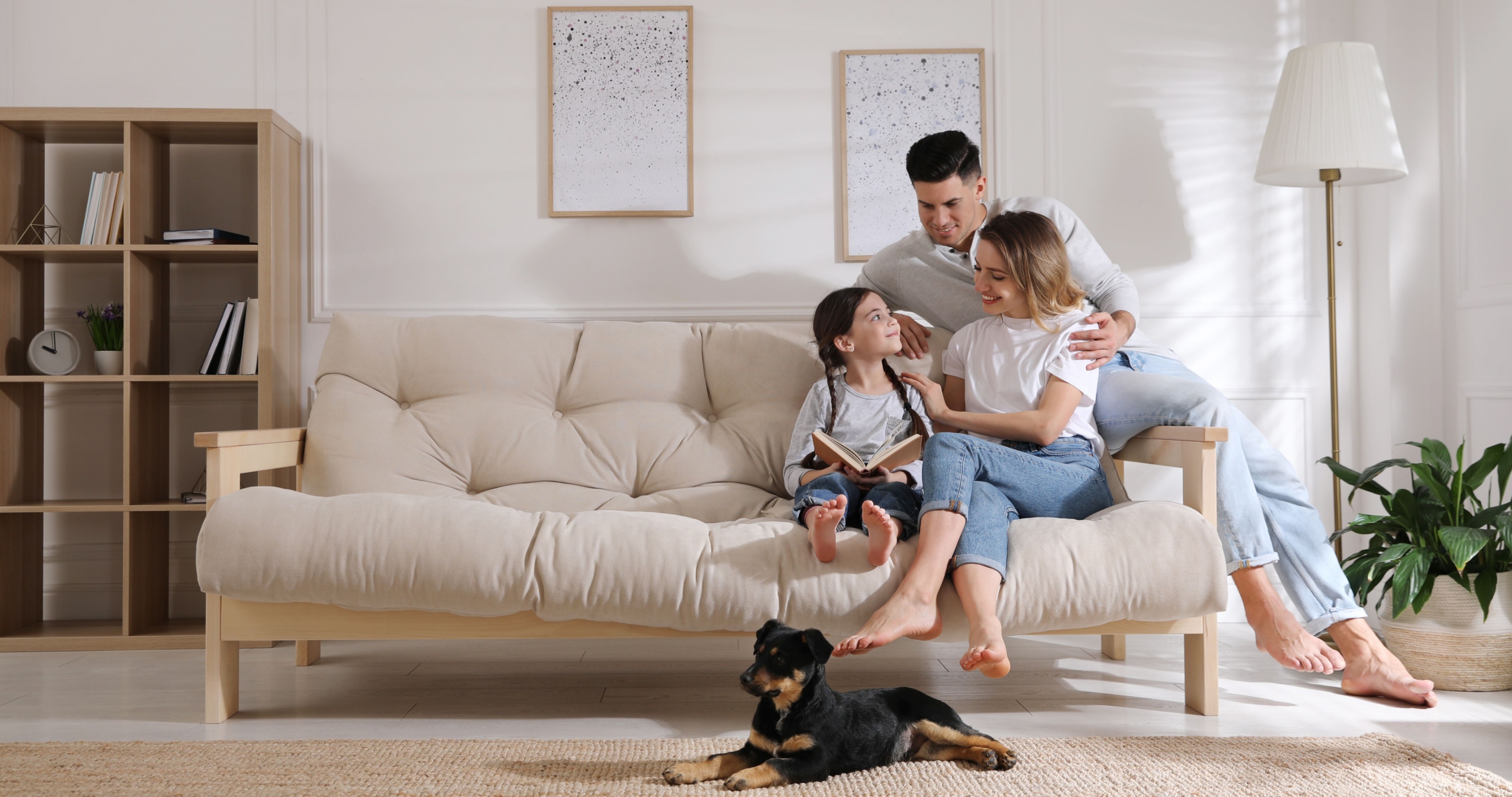 Happy family comfortable at home with their puppy