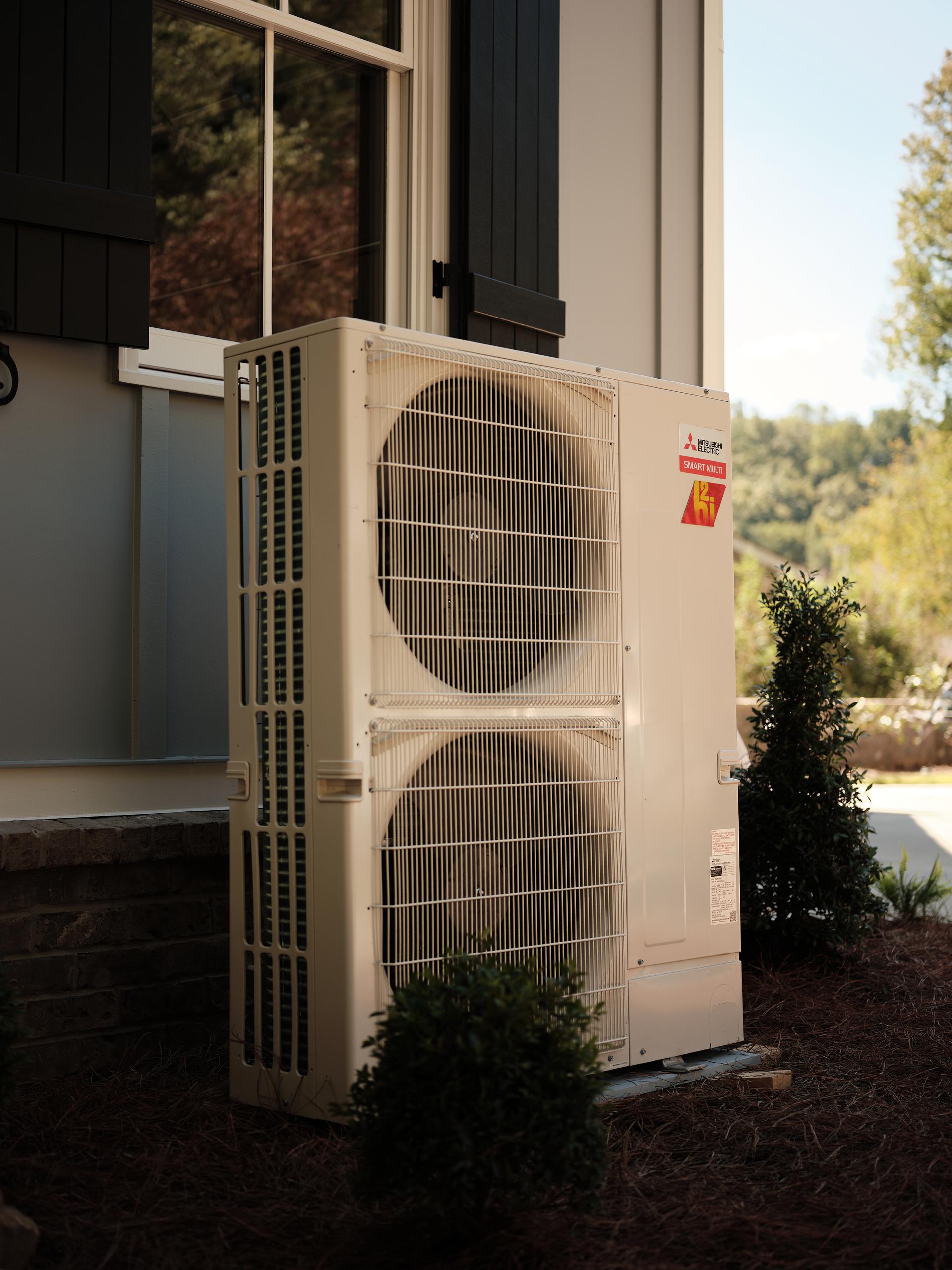 hvac system outside on the side of a white house