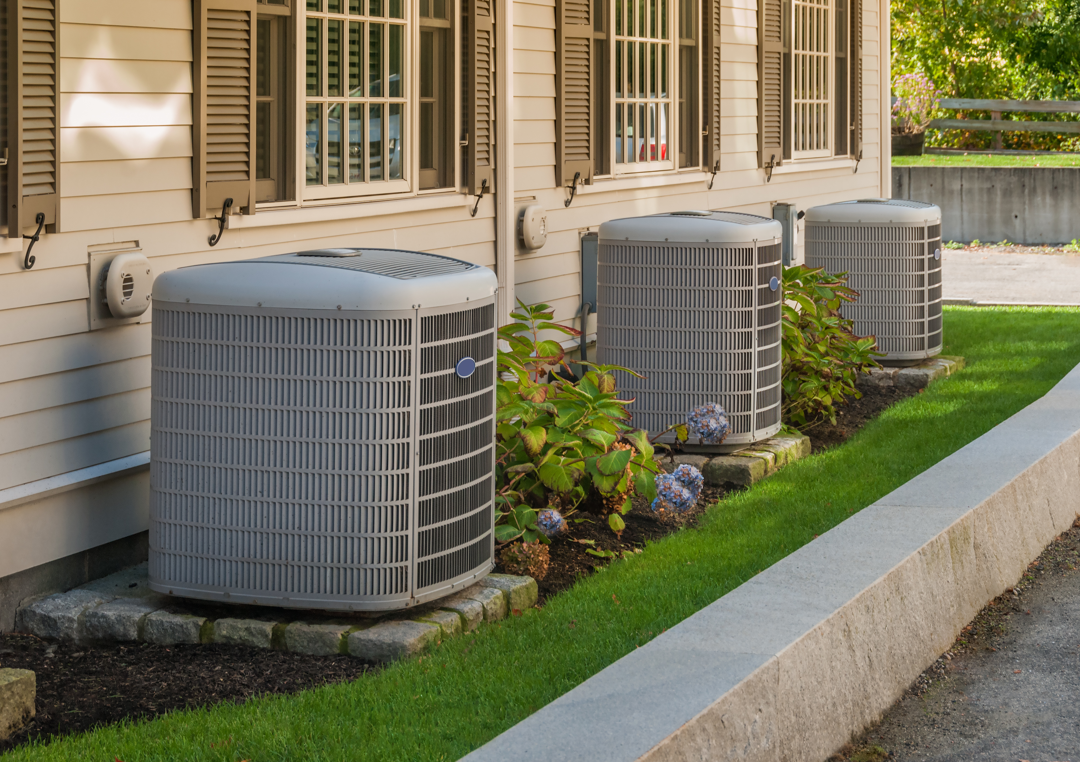 gray HVAC system on side of the house