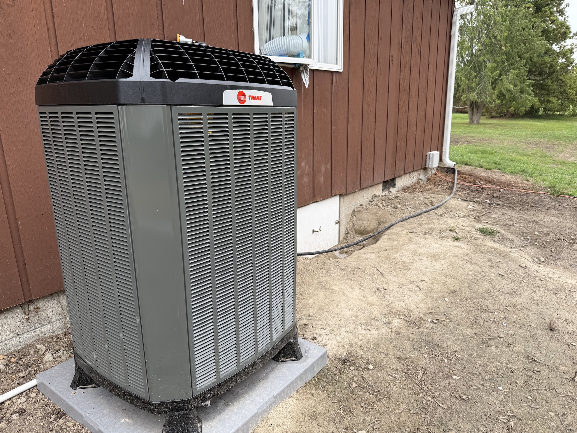 trane hvac outside of a red house