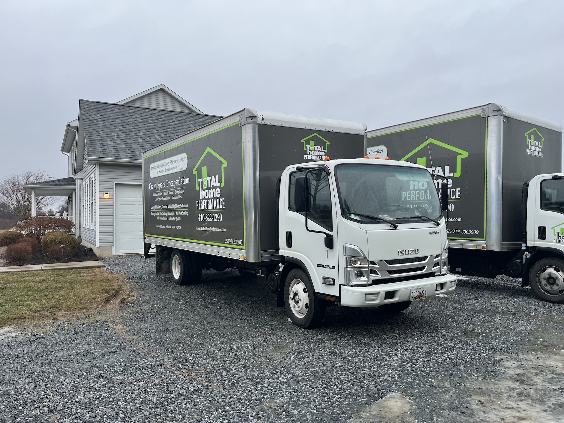 Total Home Performance trucks and vans parked outside home
