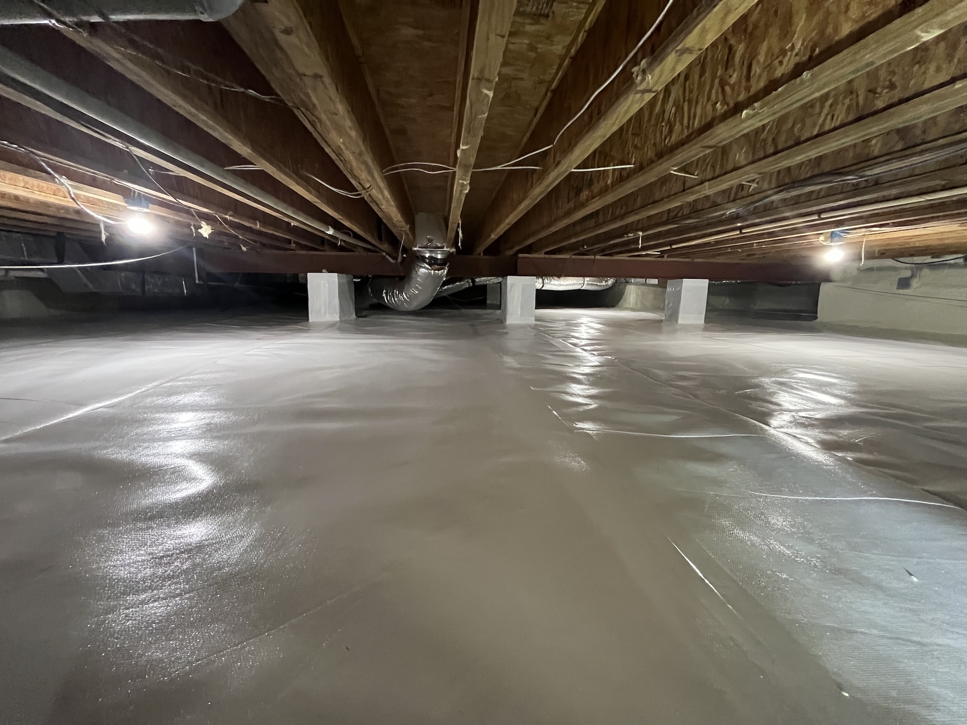 Well-lit encapsulated crawl space on Marylan's Eastern Shore with crawl space encapsulation performed by THP