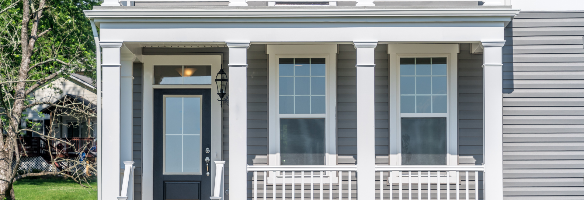 Covered porch with white columns steps to the doorway terrace