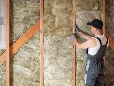 Professional insulating a wall. 