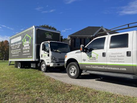 Two Total Home Performance trucks parked nose-to-nose outside Eastern Shore, Maryland home